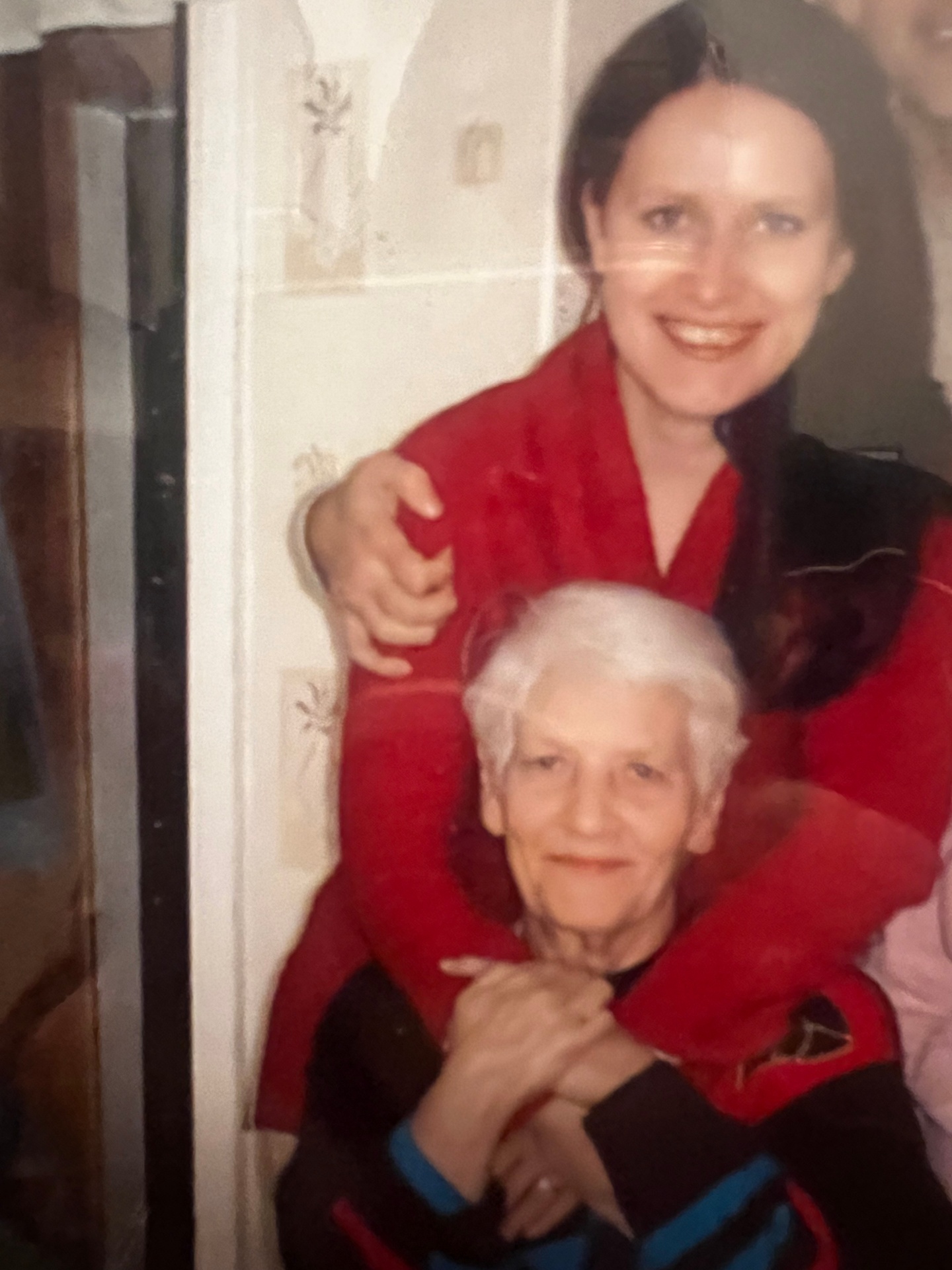 Irina, the founder of VitaNexus, embracing her grandmother in an old family photograph